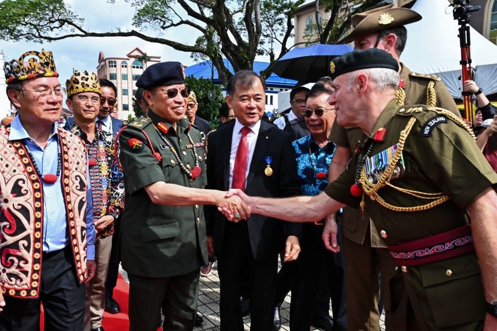Sarawak Premier Tan Sri Abang Johari Openg greets military veterans during the 80th Commemoration of the Semut Parachute Landing 1945 at Padang Merdeka in Kuching March 27, 2025. — Bernama pic
