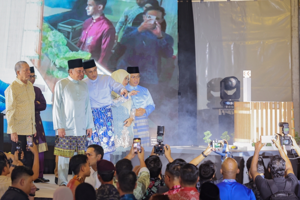 Prime Minister Datuk Seri Anwar Ibrahim (third left) observes a replica of Madani Mosque during the groundbreaking ceremony at Jalan Masjid India, Kuala Lumpur. — Bernama pic
