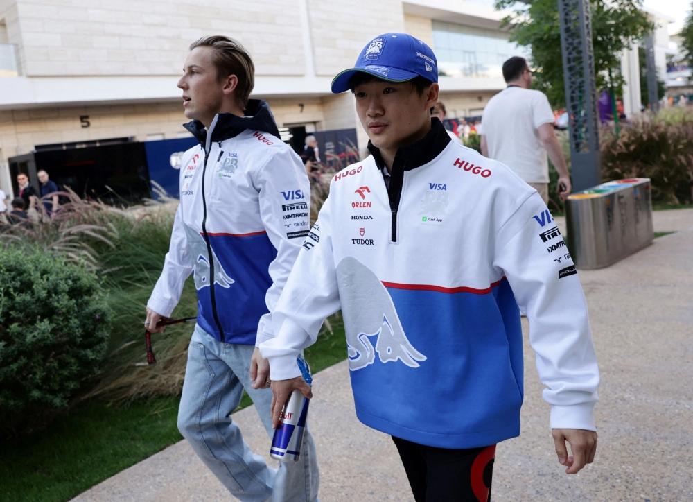 RB’s Yuki Tsunoda and Liam Lawson (left) arrive at the Lusail International Circuit in Qatar on November 29, 2024. — AFP pic