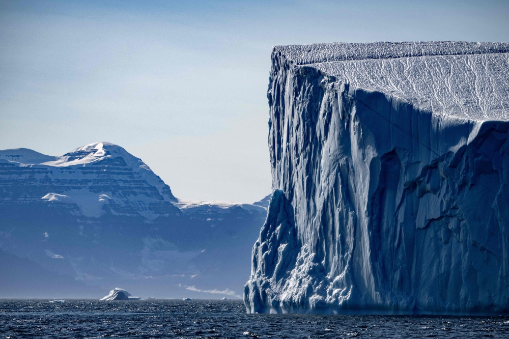 A photograph taken on August 12, 2023, shows an iceberg melting in Scoresby Fjord, Eastern Greenland. — AFP pic