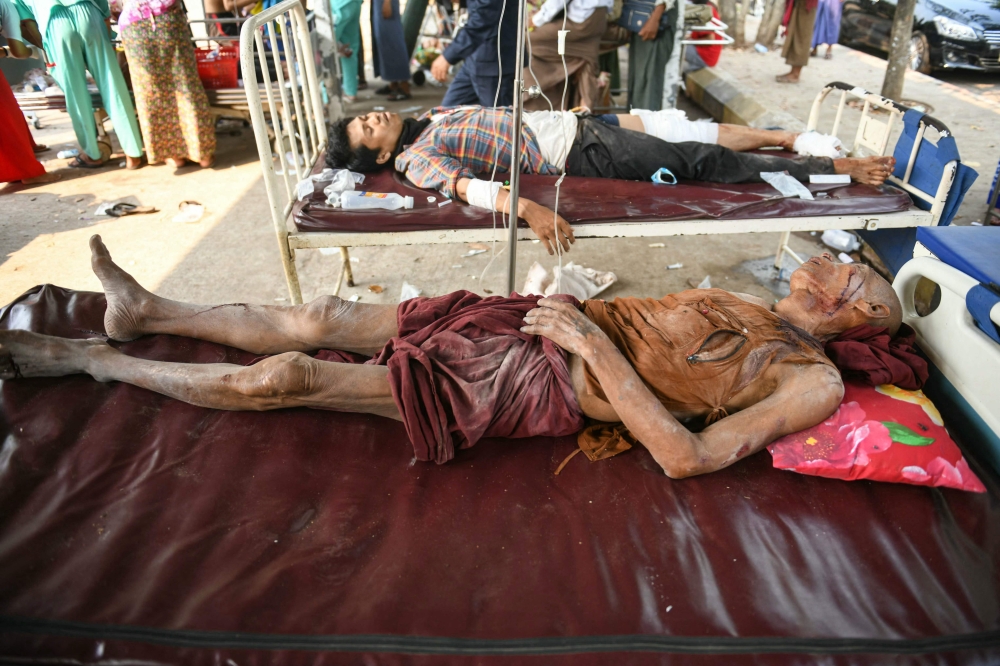 Survivors lie on beds at the compound of a hospital in Naypyidaw. — AFP pic