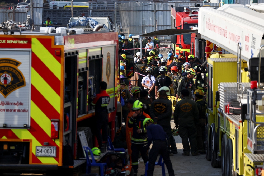 Rescue personnel work after a strong earthquake struck central Myanmar earlier. — Reuters pic