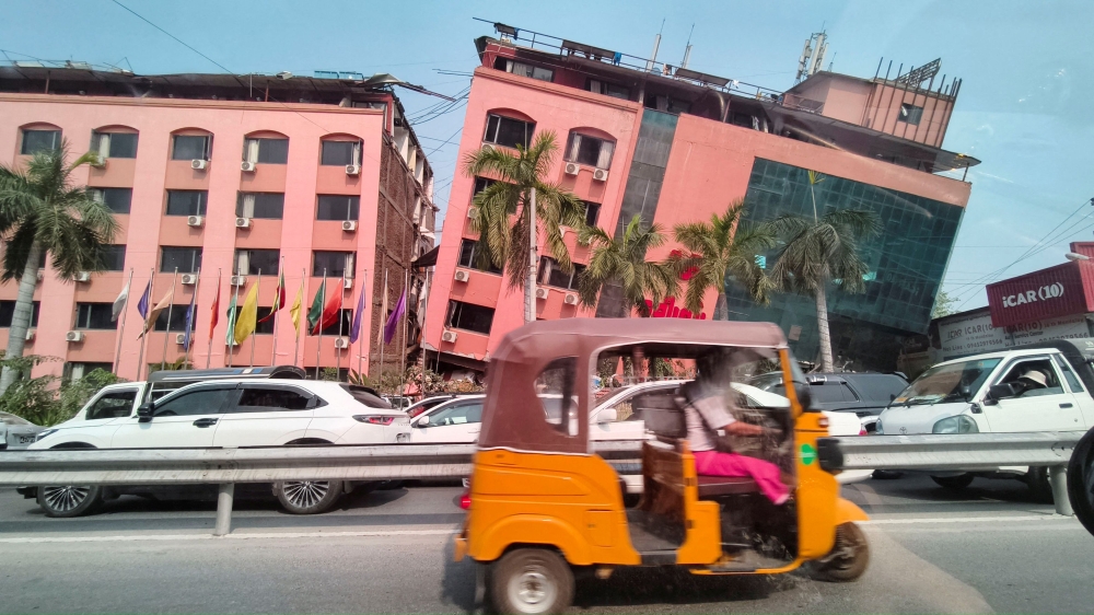 Motorists ride past a damaged building in Mandalay March 28, 2025, after a strong earthquake struck central Myanmar yesterday. — Reuters pic