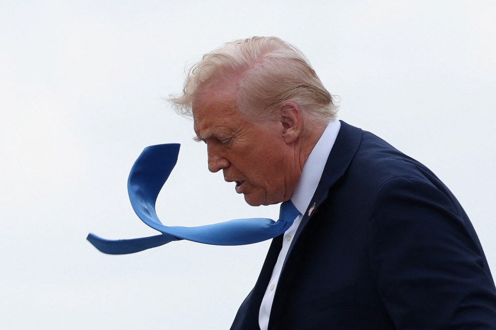 US President Donald Trump disembarks Air Force One in West Palm Beach, Florida March 28, 2025.  — Reuters pic
