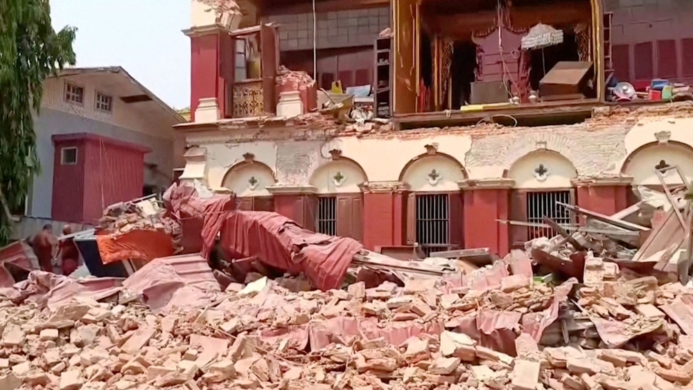 People stand near a collapsed temple following an earthquake in Mandalay, Myanmar, March 28, 2025, in this screengrab taken from social media video. — Social media pic via Reuters