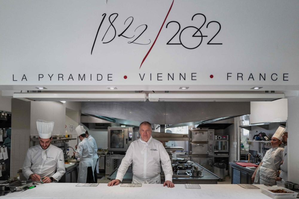 French Chef Patrick Henriroux poses for a picture in the kitchen of ‘La Pyramide’, the first three-star restaurant in the history of the Michelin Guide, in Vienne. — AFP pic