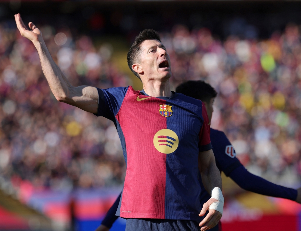 Barcelona's Polish forward Robert Lewandowski celebrates scoring his team's second goal during the Spanish league football match against Girona FC. — AFP pic