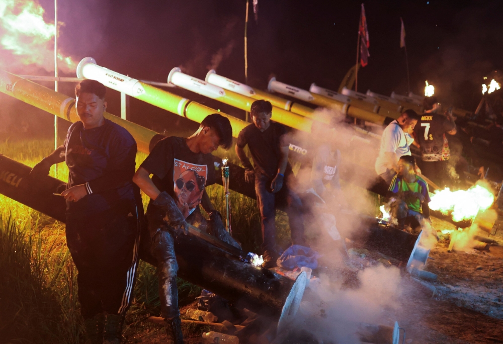 Villagers fire steel cannons in Kampung Talang as part of a tradition to welcome Hari Raya Aidilfitri. — Reuters pic