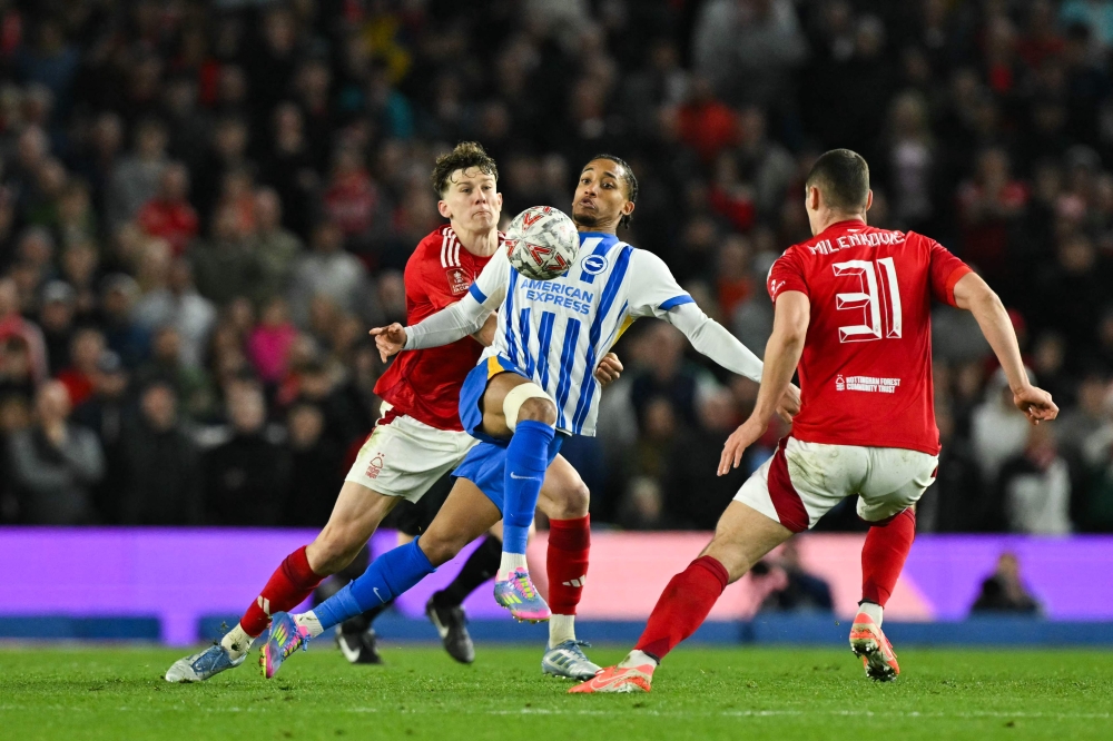 Brighton's Brazilian striker #09 Joao Pedro (centre) fights for the ball with Nottingham Forest's English midfielder #22 Ryan Yates (left) during the English FA Cup quarter-final football match between Brighton & Hove Albion and Nottingham Forest at the Amex stadium, in Brighton March 29, 2025.
