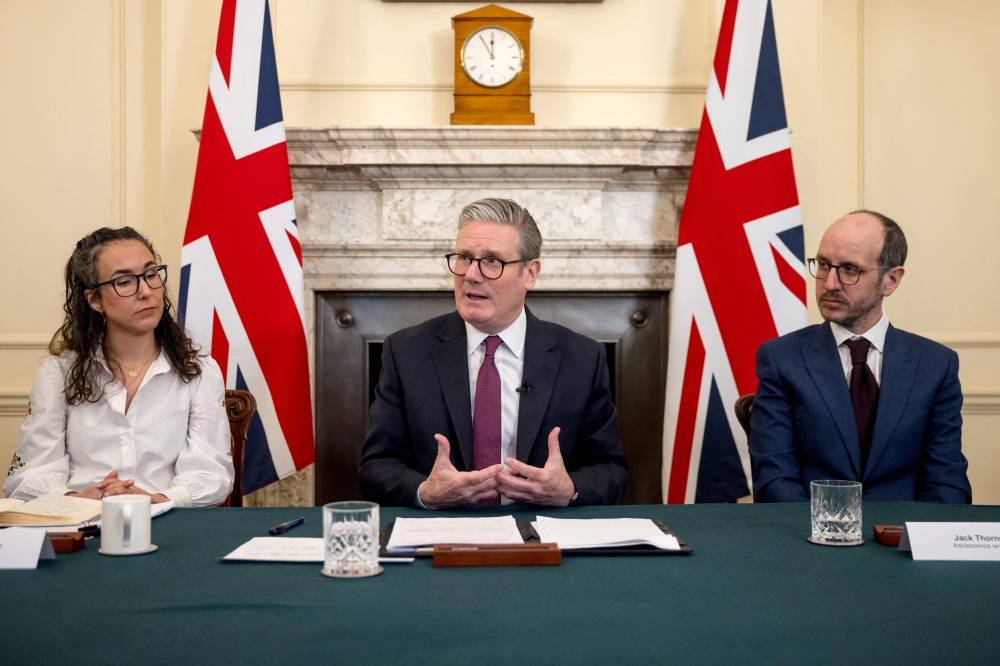 Britain's Prime Minister Keir Starmer (centre) holds a roundtable meeting with Sarah Simpkin from the Children's Society (left) and writer Jack Thorne (right) inside 10 Downing Street on March 31, 2025 in London. — AFP pool pic