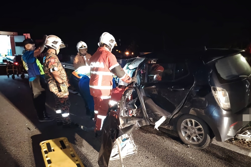 Bomba personnel extracting the passenger from the wrecked vehicle at Jln Sibu-Selangau. — Picture courtesy of the Fire and Rescue Department 