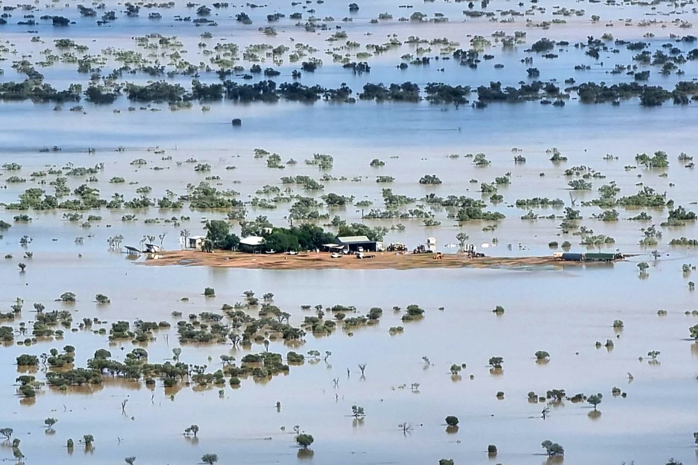 This handout photo taken on March 29 and released by The Queensland Fire Department shows a homestead under floodwaters near the town of Jundah in south-west Queensland. — AFP pic
