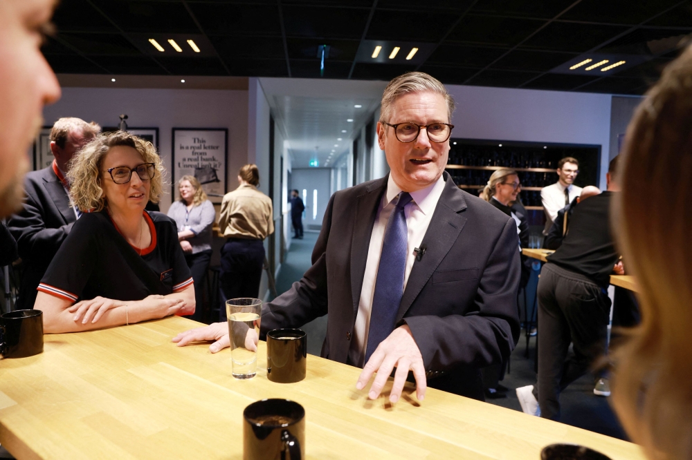 British Prime Minister Keir Starmer interacts with staff during his visit to the Nationwide Building Society office in the city of London, Britain April 1. — Reuters pic 