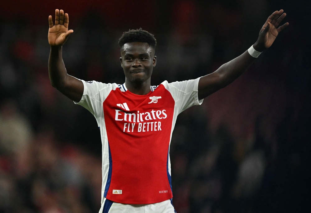 Arsenal's English midfielder Bukayo Saka applauds the fans following the English Premier League football match against Fulham. — AFP pic