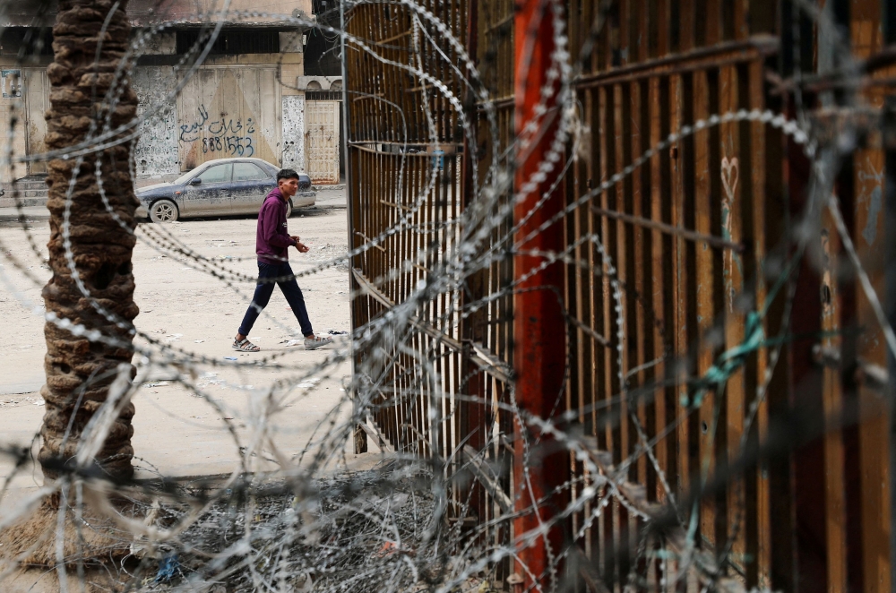 A Palestinian man walks near a bakery that has stopped operating due to a lack of flour and fuel, in Gaza City, April 1, 2025. — Reuters pic