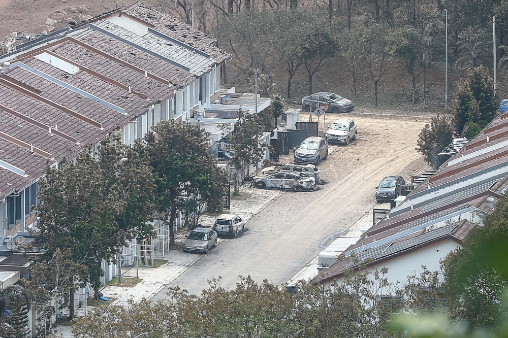 Houses and cars were seen burned due to the intense heat near ground zero following the gas pipeline fire that occurred here in Putra Heights yesterday. — Picture buy Sayuti Zanudin