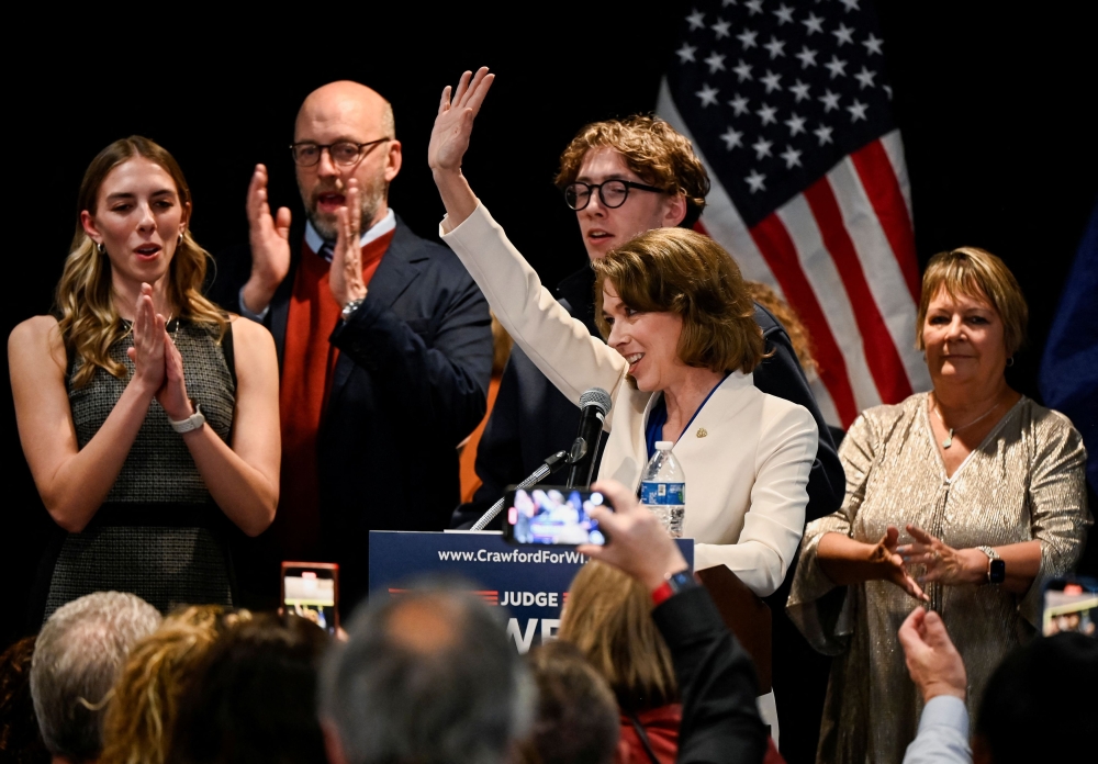 Democrat-backed Wisconsin Supreme Court candidate Judge Susan Crawford gestures to supporters after voters elected her to the state Supreme Court. — Reuters pic