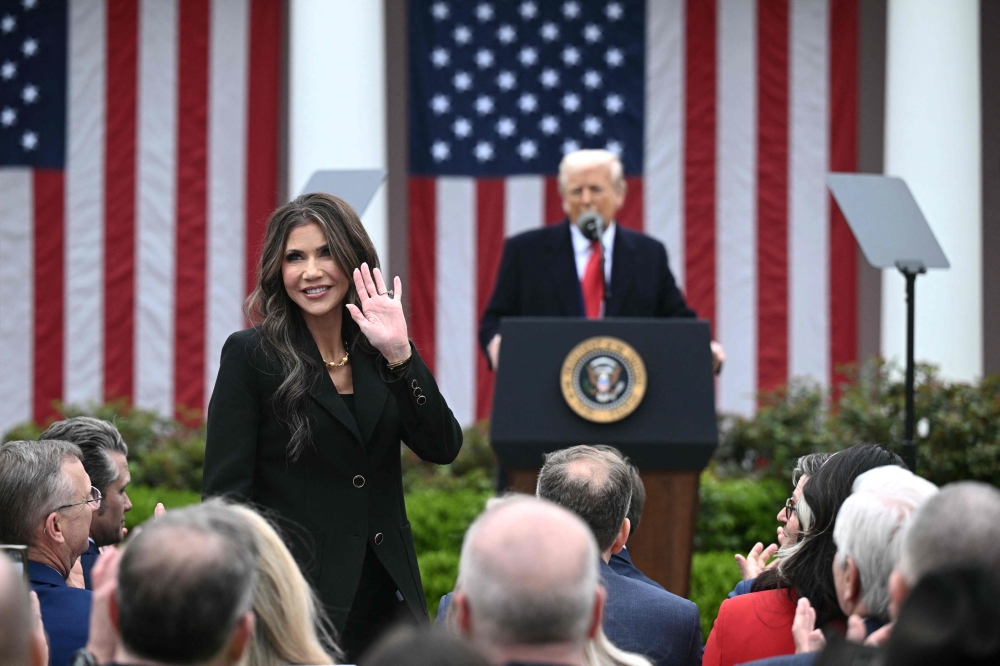 US Secretary of Homeland Security Kristi Noem waves after being acknowledged by US President Donald Trump as he delivers remarks on reciprocal tariffs during an event in the Rose Garden entitled 