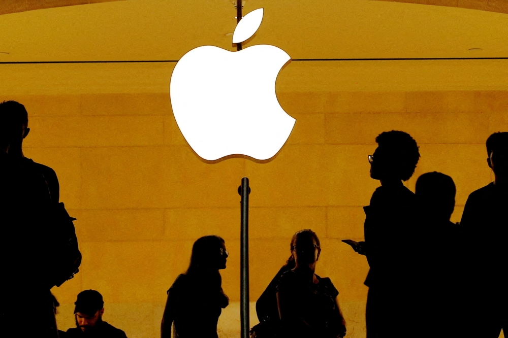 Customers walk past an Apple logo inside of an Apple store at Grand Central Station in New York, U.S., August 1, 2018. — File pic via Reuters