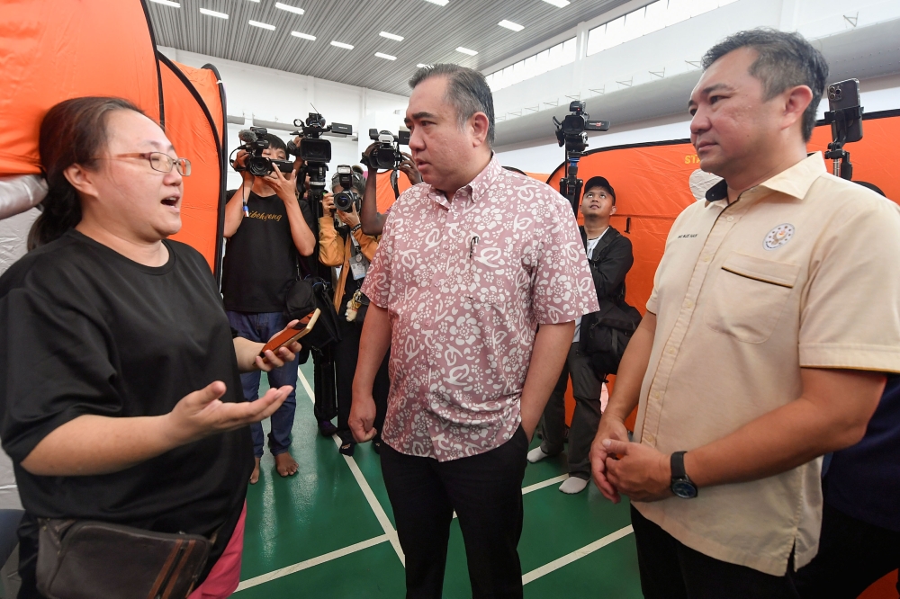 Transport Minister Anthony Loke (centre) with Selangor Investment, Trade and Mobility Exco Ng Sze Han (right) speaking to victims of the gas pipeline fire at the temporary relief centre in Masjid Putra Heights today. — Bernama pic