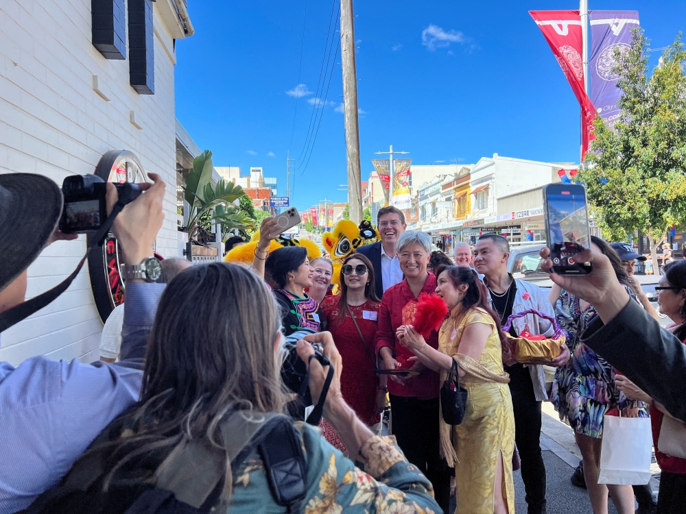 Australia’s Labor Party MP for Bennelong Jerome Laxale and Australian Foreign Minister Penny Wong pose for pictures with residents, during Chinese New Year celebrations, at Eastwood in Sydney February 2, 2025. — Reuters pic