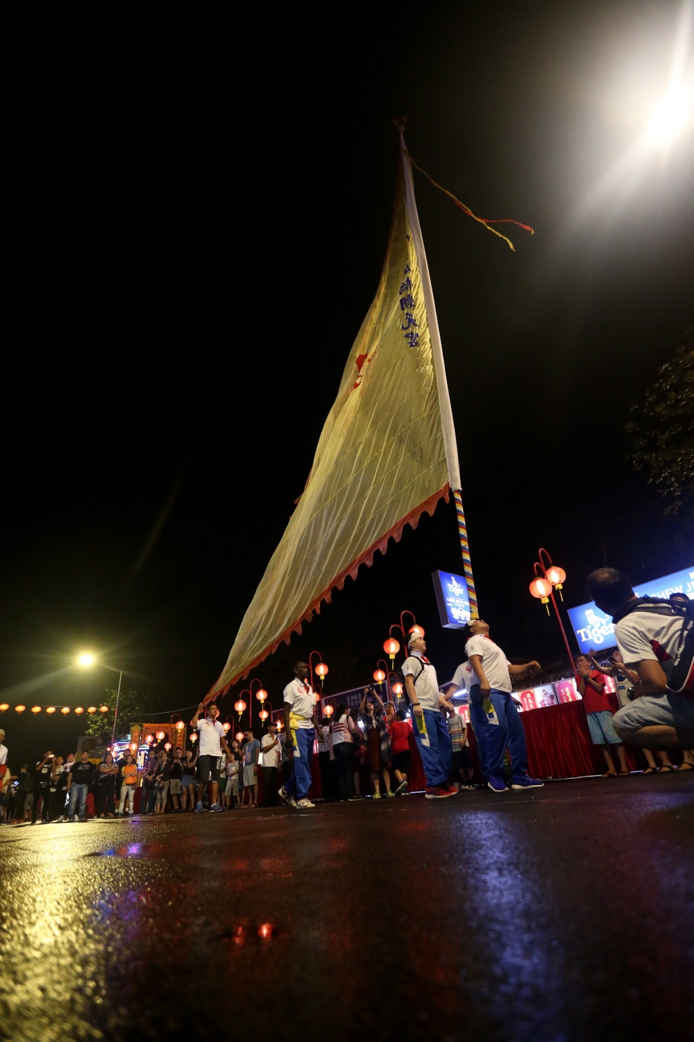 People watch the Chingay performance at the Chew Jetty in Penang February 23, 2018. The costs of making the giant flags, made of long bamboo poles and chiffon cloth, could reach hundreds of ringgit just for the poles, as they had to source straight bamboo poles of a specific length and width. — Picture by Sayuti Zainudin 