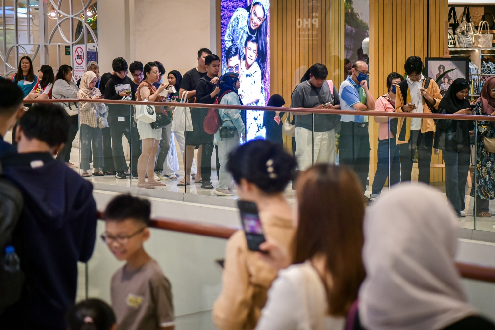 People began queuing as early as 8am to collect free books distributed by the BookXcess bookstore. — Bernama pic