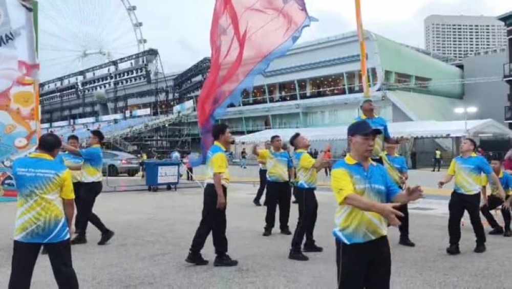 Hafiz balances a flag on his forehead during his performance at Singapore's Chingay event last month. — Picture courtesy of Hafiz Shapie 