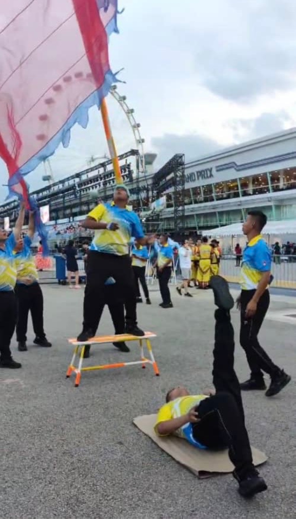 Chingay acrobatics involve one performer flipping the giant flag to be caught by another performer with their mouth or their forehead. — Picture courtesy of Hafiz Shapie 