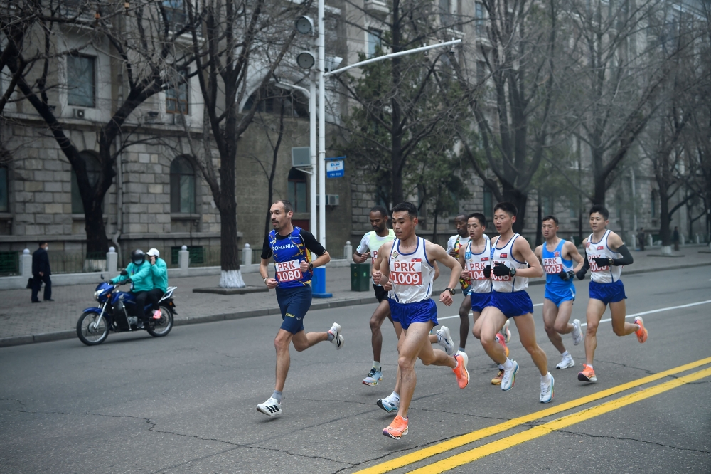 Participants take part in the 31st Pyongyang International Marathon. — AFP pic