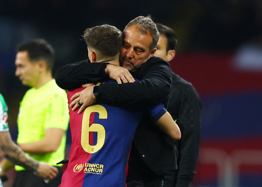 FC Barcelona's Gavi celebrates scoring their first goal with FC Barcelona coach Hansi Flick. — Reuters pic