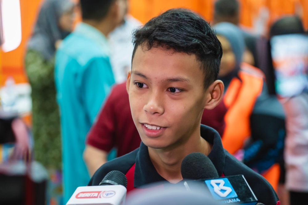Sixteen-year-old Mohd Aidil Ashraf Mohd Nizam looks forward to returning to school, especially with transportation provided. — Bernama pic 