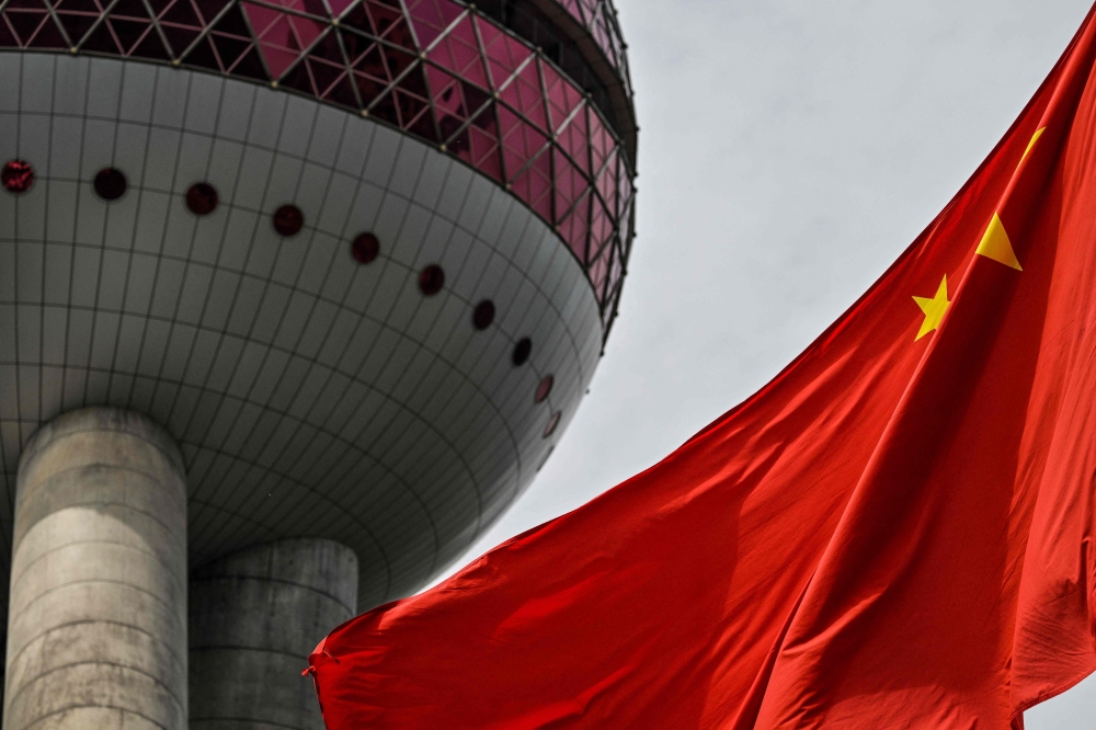 A Chinese flag is seen in the financial district of Shanghai on April 7, 2025. — AFP pic