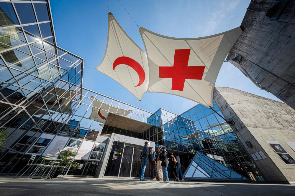 This photograph shows the Red Cross and a Red Crescent displayed on stretched canvas at the entrance of the International Red Cross and Red Crescent Museum in Geneva March 30, 2025.  — AFP pic