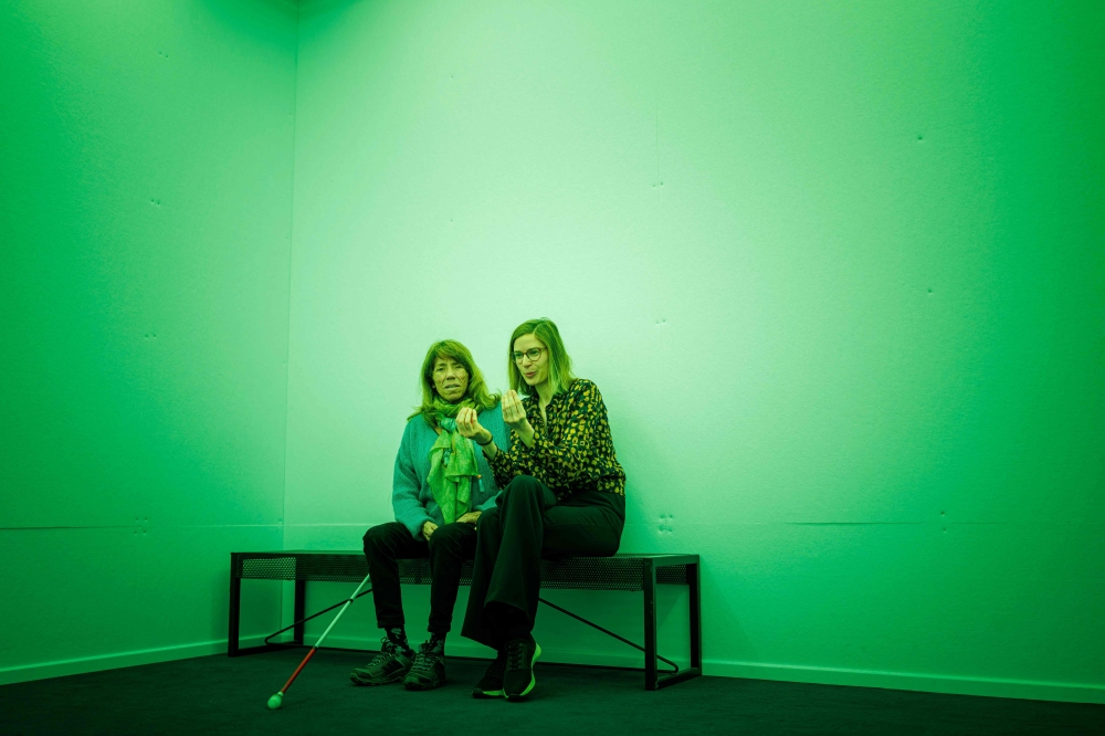 Karin (left) and her image whisperer Alice Baronnet sit in a green room as they take part in a guided tour for visually impaired people at the International Red Cross and Red Crescent Museum in Geneva March 30, 2025. Since the end of last year, the museum has been using these image whisperers to promote the inclusion of people with visual impairments. — AFP pic