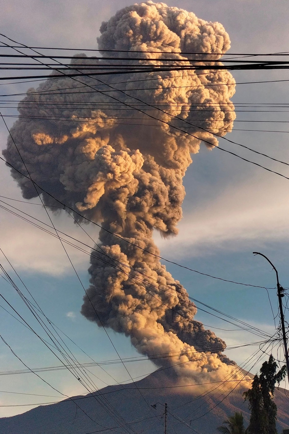 This handout photo taken from the Facebook account of Channel Nicor of C.N. Photography on April 8, 2025 shows Mount Kanlaon erupting as seen from a village in La Castellana, Negros Occidental Province. — AFP
