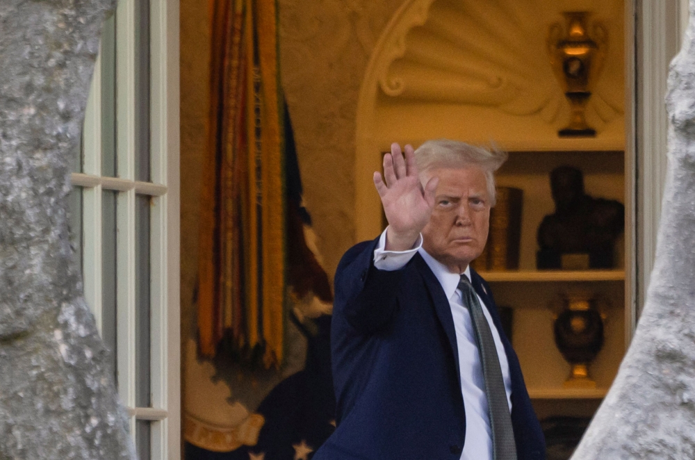 US President Donald Trump waves as he enters the White House in Washington, DC, US March 17, 2025. — Reuters pic