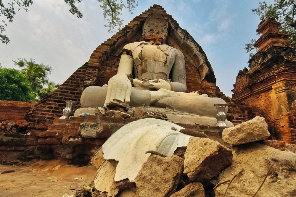 A damaged Buddha statue is pictured in Inn Wa on the outskirts of Mandalay on April 6, 2025, following the devastating March 28 earthquake. — AFP pic