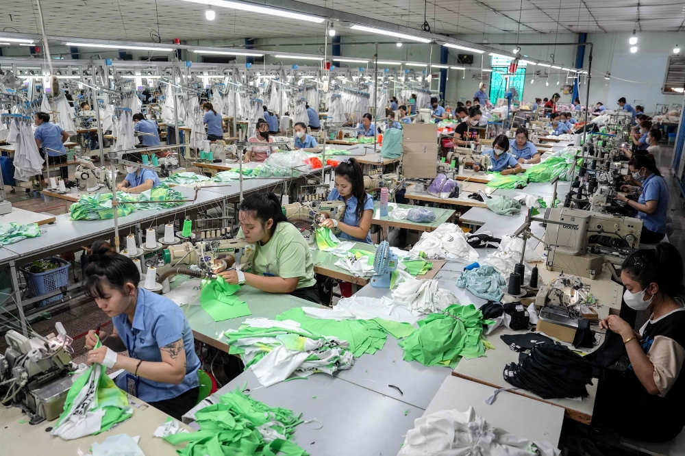 Vietnamese garment factory workers stitch apparel at a factory in Ho Chi Minh City on April 3, 2025, after US President Donald Trump unveiled sweeping new tariffs on trading partners. — AFP pic