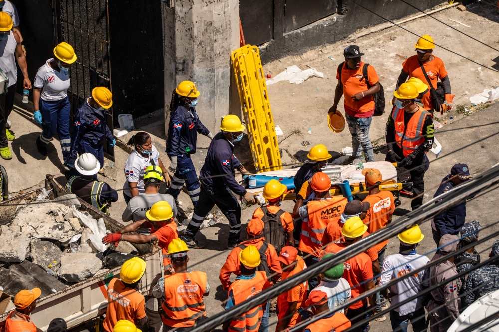 Personnel from civil defense and firefighters work at the Jet Set nightclub following the collapse of its roof in Santo Domingo on April 8, 2025. — AFP pic