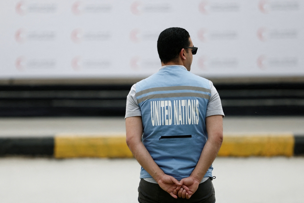 A UN staff member stands at Egyptian Red Crescent warehouses storing aid for Gaza, in the Egyptian border town of El-Arish April 8, 2025. — Benoit Tessier/Pool/AFP pic 