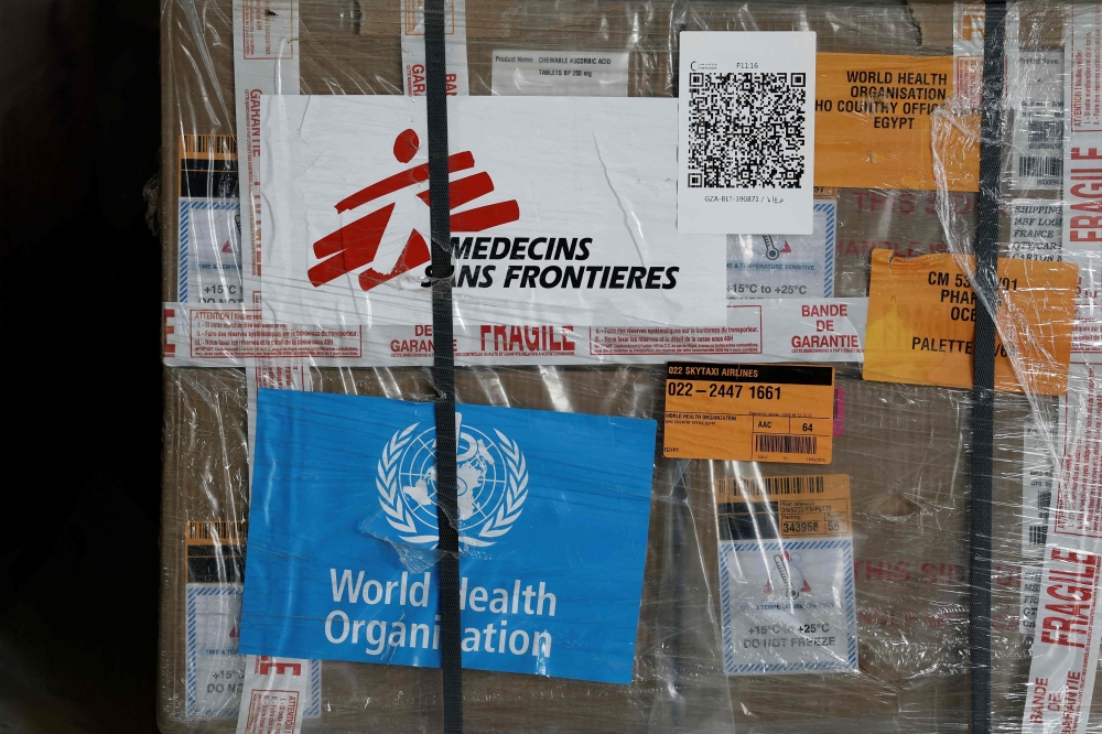 MSF (Medecins Sans Frontieres — Doctors without borders) logo and World Health Organisation (WHO) logo are seen on humanitarian supplies for Gaza sored at Egyptian Red Crescent warehouses storing aid for Gaza, in the Egyptian border town of El-Arish April 8, 2025. — Benoit Tessier/Pool/AFP pic 