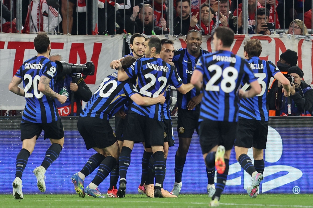 Inter Milan's Argentine forward #10 Lautaro Martinez (centre) celebrates scoring the opening goal with his teammates during the Uefa Champions League first leg quarter-final football match between FC Bayern Munich and Inter Milan in Munich April 8, 2025. — AFP pic