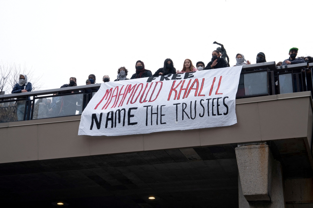Student demonstrators watch as others chain themselves to the gates of St. Paul’s Chapel at Columbia University to denounce the arrest of Mahmoud Khalil in New York City, U.S., April 2, 2025.
