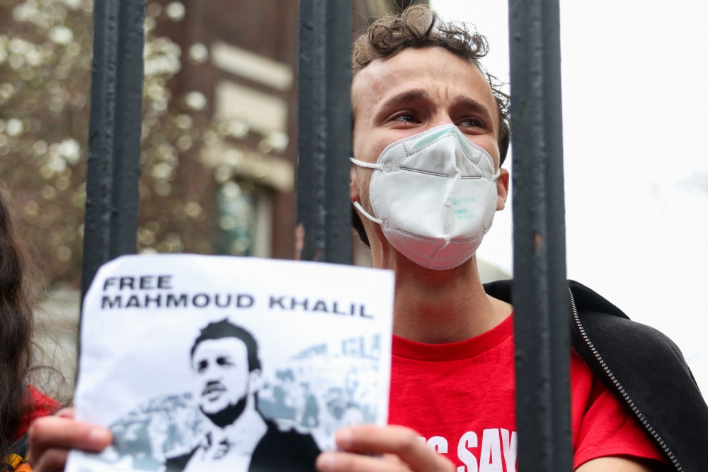 A demonstrator tears up as he protests the arrest of Mahmoud Khalil by chaining himself to gates at Columbia University in New York City April 2, 2025. 