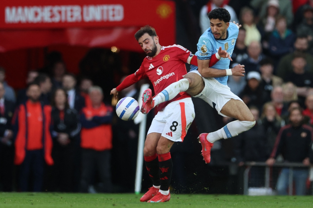 Manchester United's Portuguese midfielder #08 Bruno Fernandes (left) vies with Manchester City's Egyptian striker #07 Omar Marmoush (right) during the English Premier League football match between Manchester United and Manchester City at Old Trafford in Manchester April 6, 2025. — AFP pic
