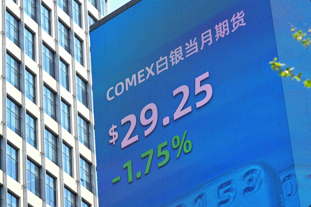 A screen with a stocks indicator is seen in the Jing'an district in Shanghai on April 9, 2025. — AFP pic