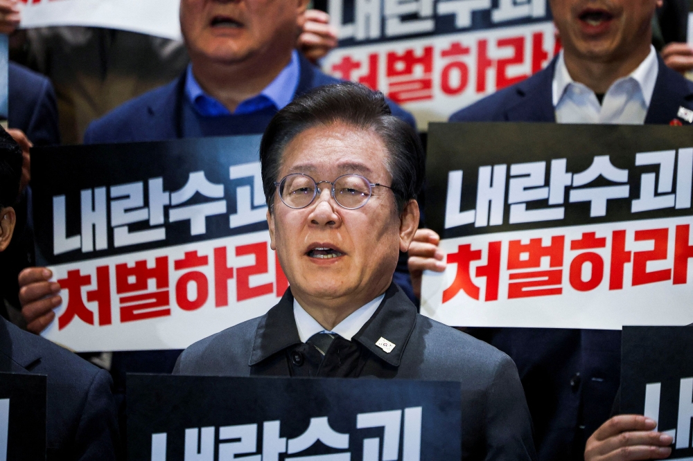 Lee Jae-myung, the leader of South Korea's main opposition party Democratic Party of Korea, and lawmakers attend a press conference after South Korean President Yoon Suk-yeol, who declared martial law which was reversed hours later, survived an impeachment motion, at the National Assembly in Seoul December 7, 2024. 