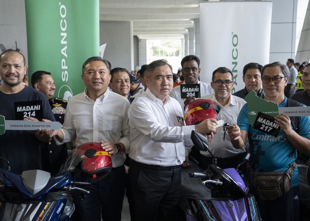 Transport Minister Anthony Loke hands over 55 motorcycles to the victims of the gas pipeline explosion tragedy in Putra Heights, contributed by Spanco in collaboration with the Transport Ministry. With him is Selangor exco Ng Sze Han. — Picture from Facebook/Ng Sze Han