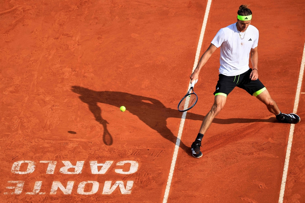 Germany's Alexander Zverev returns the ball to Italy's Matteo Berrettini during the Monte Carlo ATP Masters Series Tournament round of 32 tennis match on the Rainier III court at the Monte Carlo Country Club in Roquebrune-Cap-Martin April 8, 2025. — AFP pic